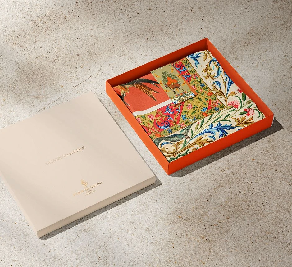 Luxury silk twilly scarf design with floral and botanical pattern, presented in a branded gift box.