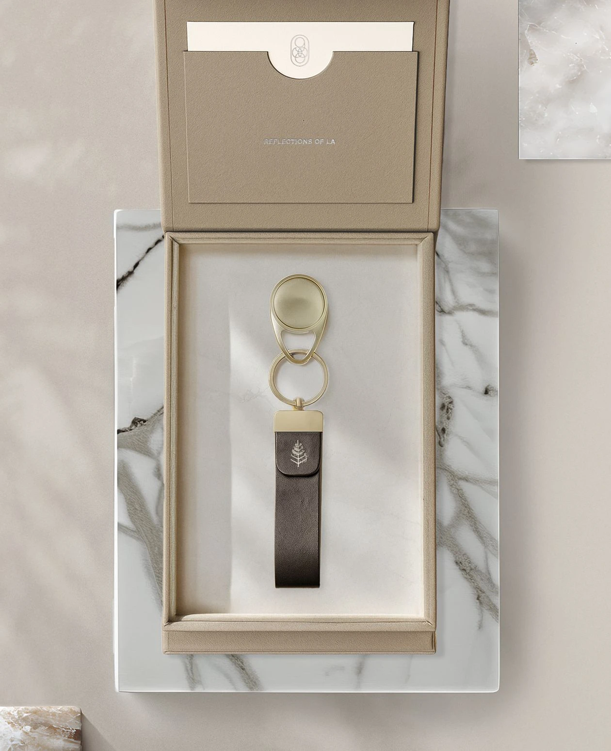 Luxury key packaging design for Four Seasons featuring a leather key fob in a minimalist presentation box.