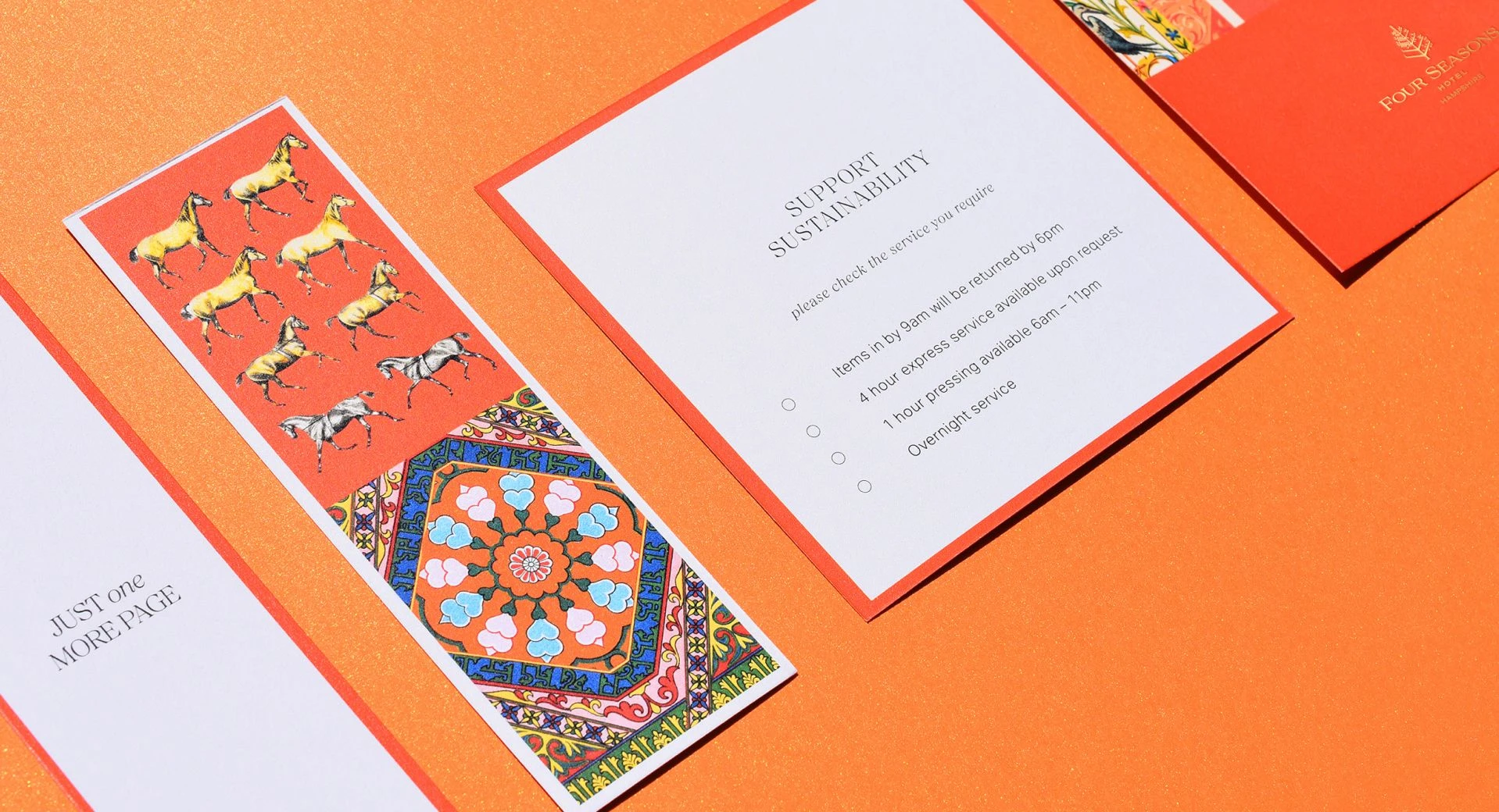 Flat lay of Four Seasons printed cards featuring illustrated patterns, horse motifs, and a ‘Support Sustainability’ message on an orange background.