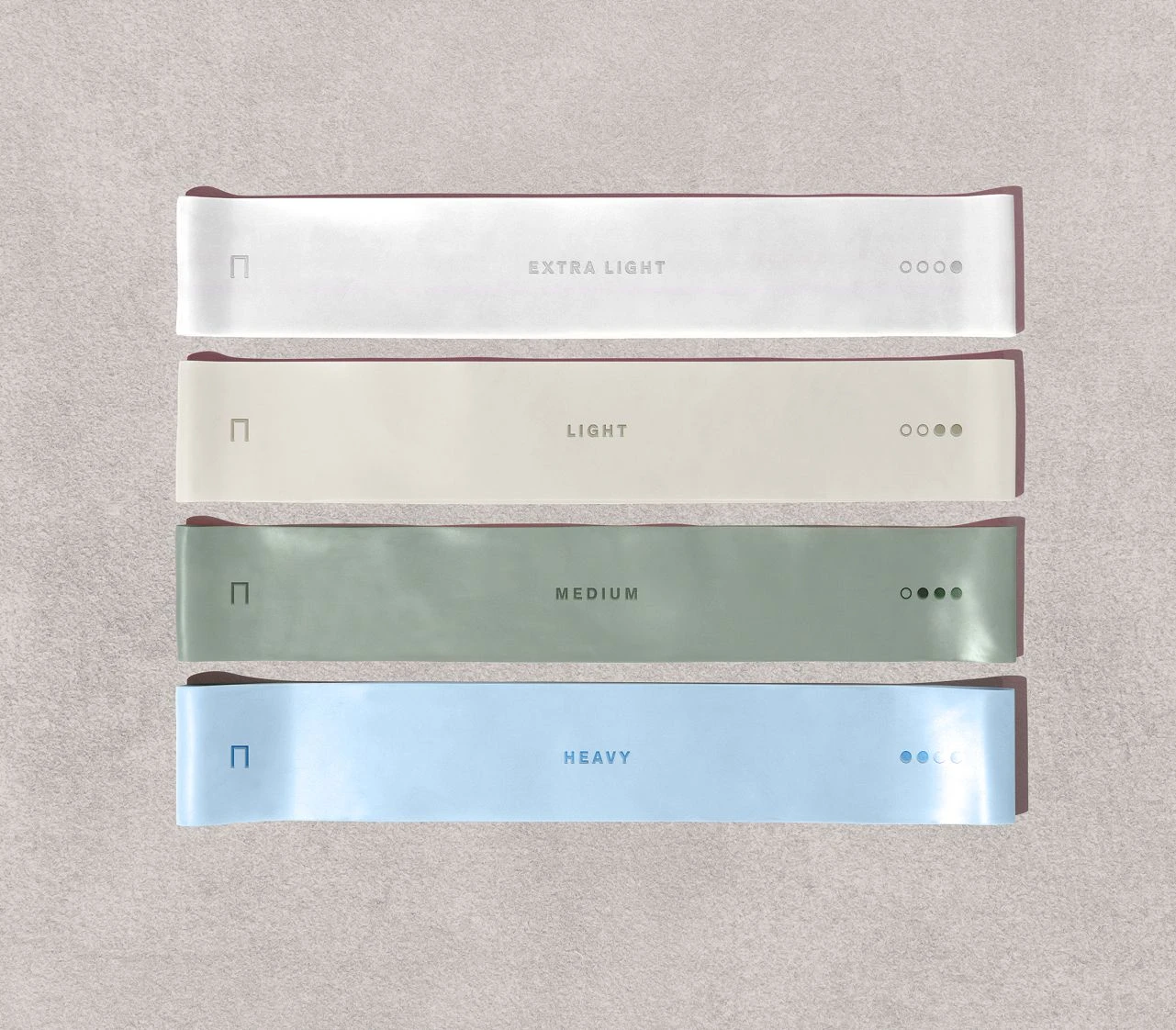 Sensei resistance band set with extra light, light, medium, and heavy strength levels shown in neutral colour tones