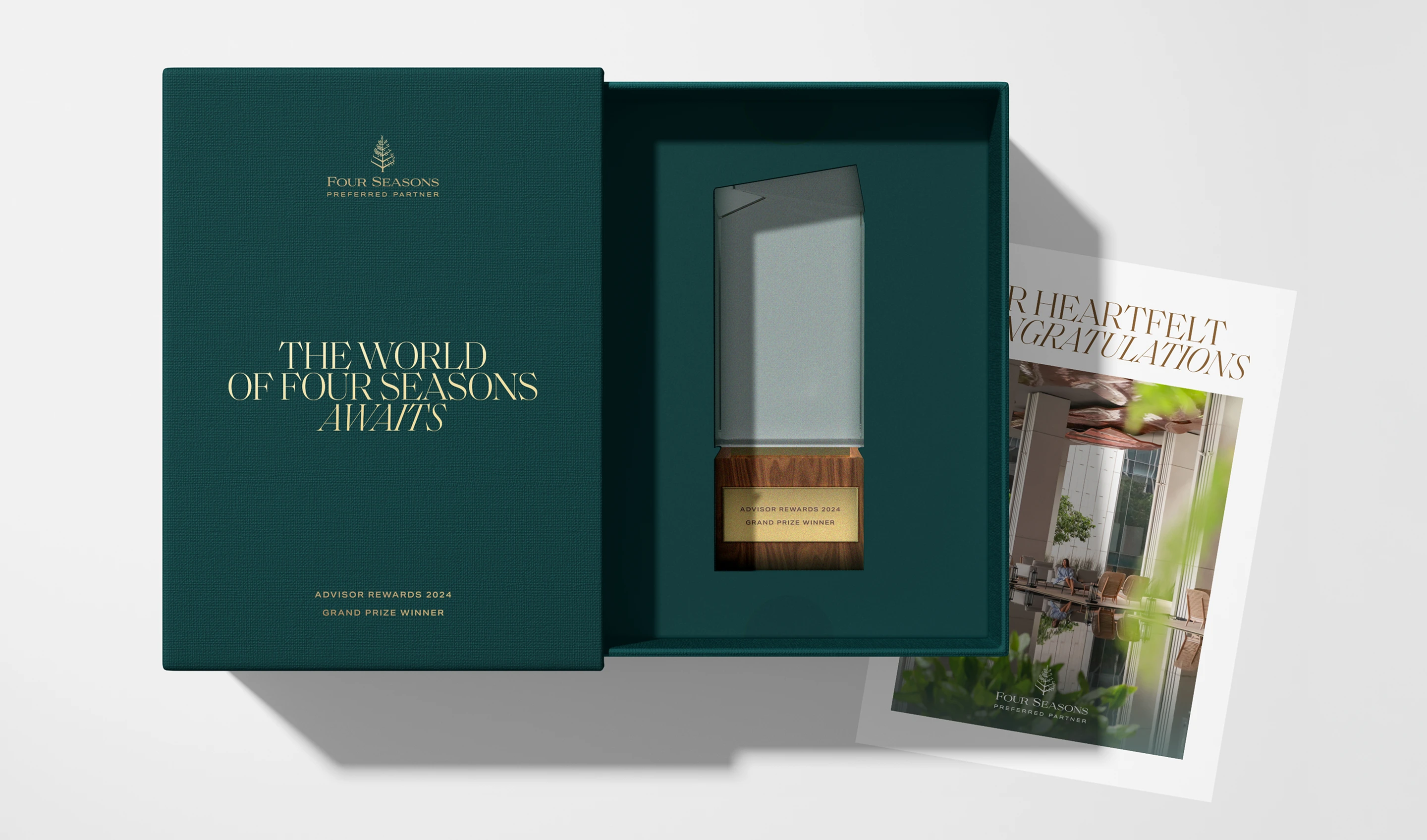 Four Seasons corporate award packaging with presentation box, glass trophy, and congratulatory print card